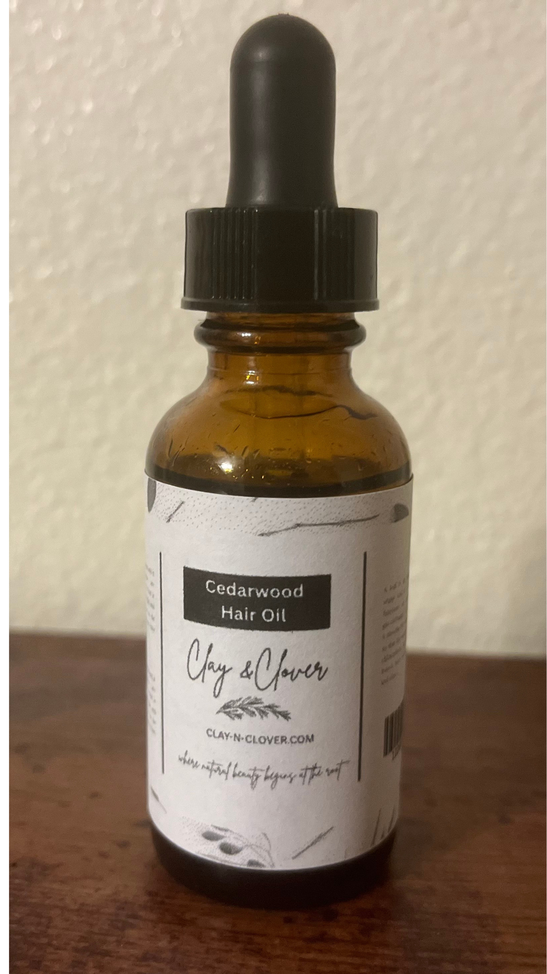 “Clay-N-Clover Cedarwood Hair Oil in amber bottle — earthy natural scalp oil infused with cedarwood, olive oil, and vitamin E to strengthen roots, reduce dryness, and promote healthy hair growth.”