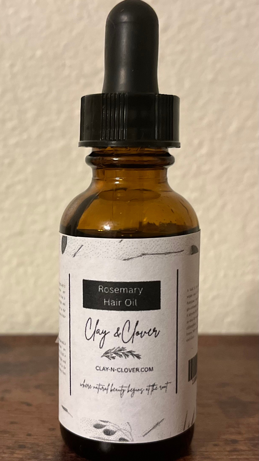 “Clay-N-Clover Rosemary Hair Oil in amber bottle — natural growth treatment infused with rosemary and olive oils to strengthen hair, nourish scalp, and support healthy regrowth.”