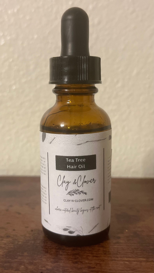 “Clay-N-Clover Tea Tree Hair Oil in amber bottle — natural scalp treatment infused with tea tree, olive oil, and vitamin E for soothing, healthy hair growth.”