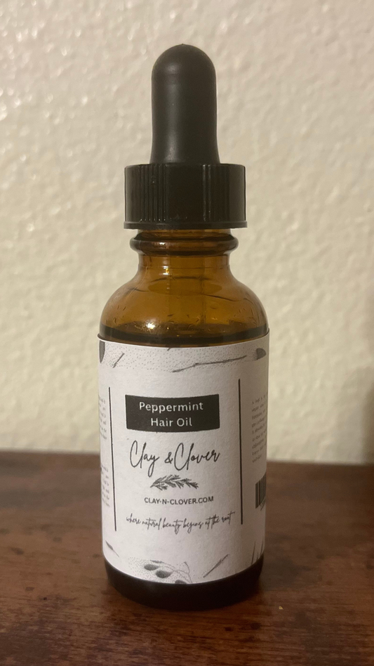 “Clay-N-Clover Peppermint Hair Oil in amber bottle — refreshing natural scalp oil infused with peppermint, olive oil, and vitamin E to stimulate growth and soothe dryness.”